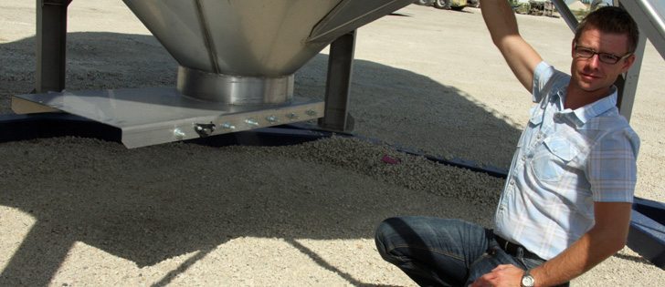 Novid's new stainless steel hopper bottom bin should last 30 years or longer, according to company manager Brent Friesen. Friesen says every component attached to the bin is stainless steel. When stainless steel must meet mild steel, an extra stainless plate is welded to the main assembly and heavy bolts are used to secure the blue mild steel skid to the stainless bottom. | Ron Lyseng photo