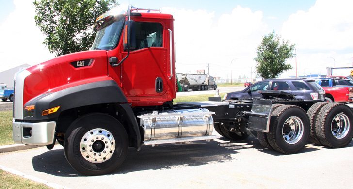 Caterpillar is entering the tandem truck market with this CT660, which has been designed for muddy filed conditions, with standard features like 120,000 pound capacity tow hooks and individual hydraulic steering boxes for left and right front wheels. | Ron Lyseng photo