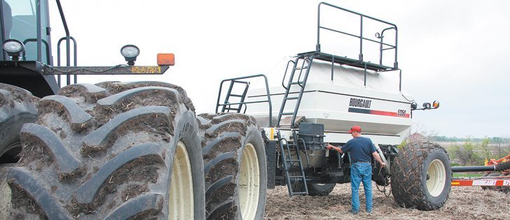 Lance Stockbrugger checks equipment before continuing to seed oats near Leroy, Sask.  |   Karen Morrison photo
