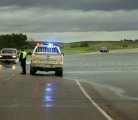 RCMP direct traffic on Hwy 16, 1 Km east of Elfros, Sask., after flash flooding covered the highway. Many towns in eastern Saskatchewan and western Manitoba declared states of emergency as rain continued to fall in the region June 30. | Robin Booker photo