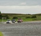 RCMP direct traffic on Highway 16, 1 Km. east of Elfros, Sask., after flash flooding covered the highway June 30, 2014. | Robin Booker photo