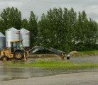 Flash flooding causes municipalities to cut roads and farmers to build dikes in eastern Saskatchewan, June 30, 2014. | Robin Booker photo