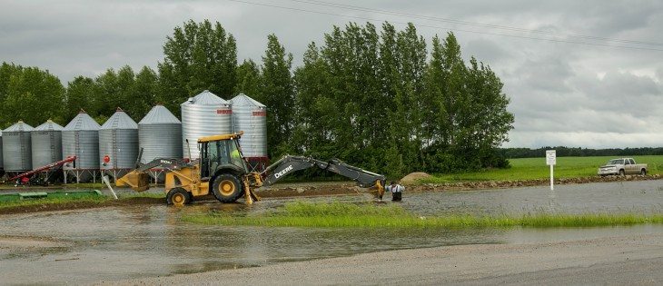 Flash flooding causes municipalities to cut roads and farmers to build dikes in eastern Saskatchewan, June 30, 2014. | Robin Booker photo