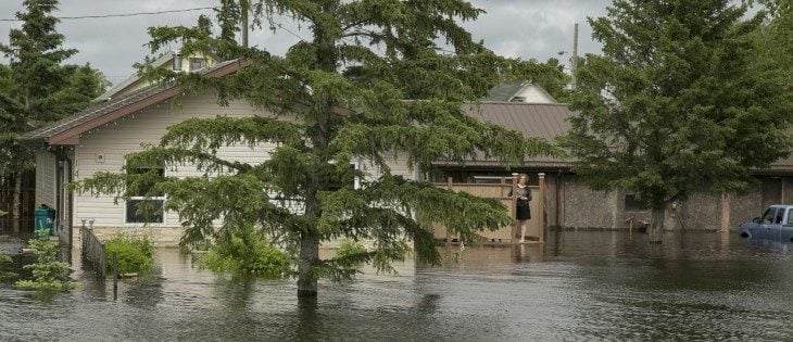 Residents of Fenwood try to pump out the town. Norah Stopa, a resident ofthe town said a neighbour woke she and husband Laurie up at 4 am on June 31. He said the water was juststarting to run into the town, and within two hours his house was flooded. | Robin Booker photo