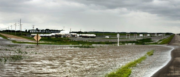 Flood water flows over a grid road on the south side of Highway 16, 3 Km. west of Foam Lake, Sask. | Robin Booker photo