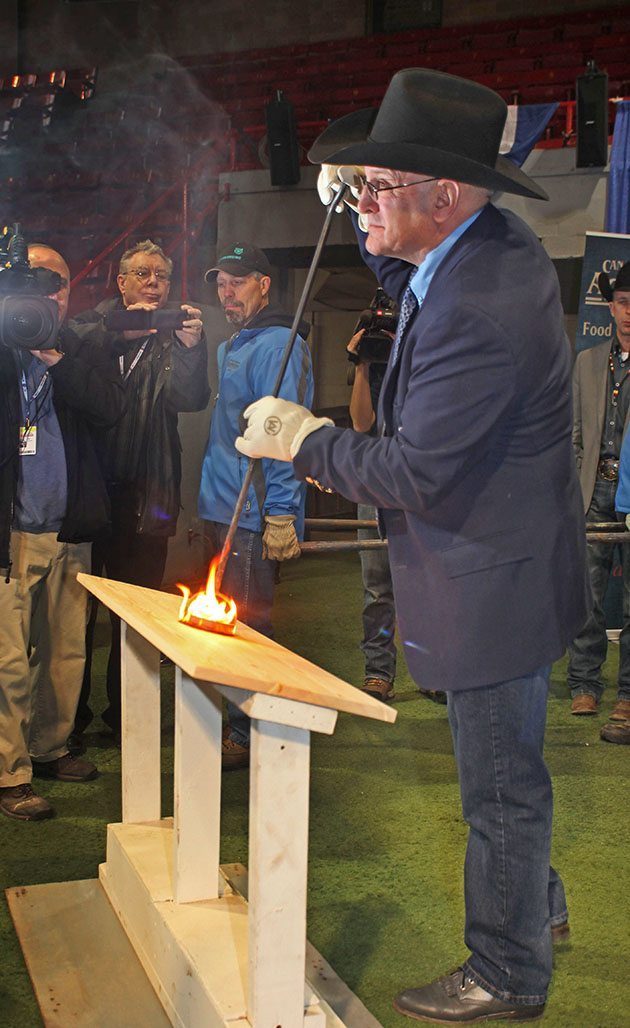 Agribition president Reed Andrew burns the brand to officially open the 44th show. | Mike Raine photo