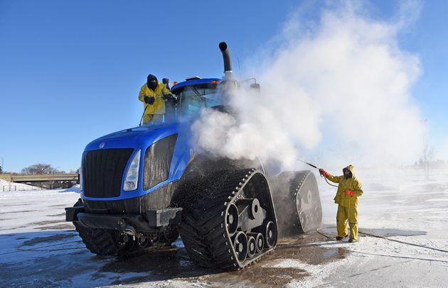 Jed Lawson and Lee Bendig of Williams Mobile Power Wash rinse a New Holland T9600 in -30 C at Prairieland Park in preparation for Crop Production Show, Jan. 12-15. | William DeKay photo