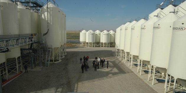 A tour group stands amid the bin farm at the Bayer CropScience canola seed cleaning facility in Lethbridge Oct. 1. The plant is about to start its busy season as its 250 contract growers start delivering product. | Barb Glen photo