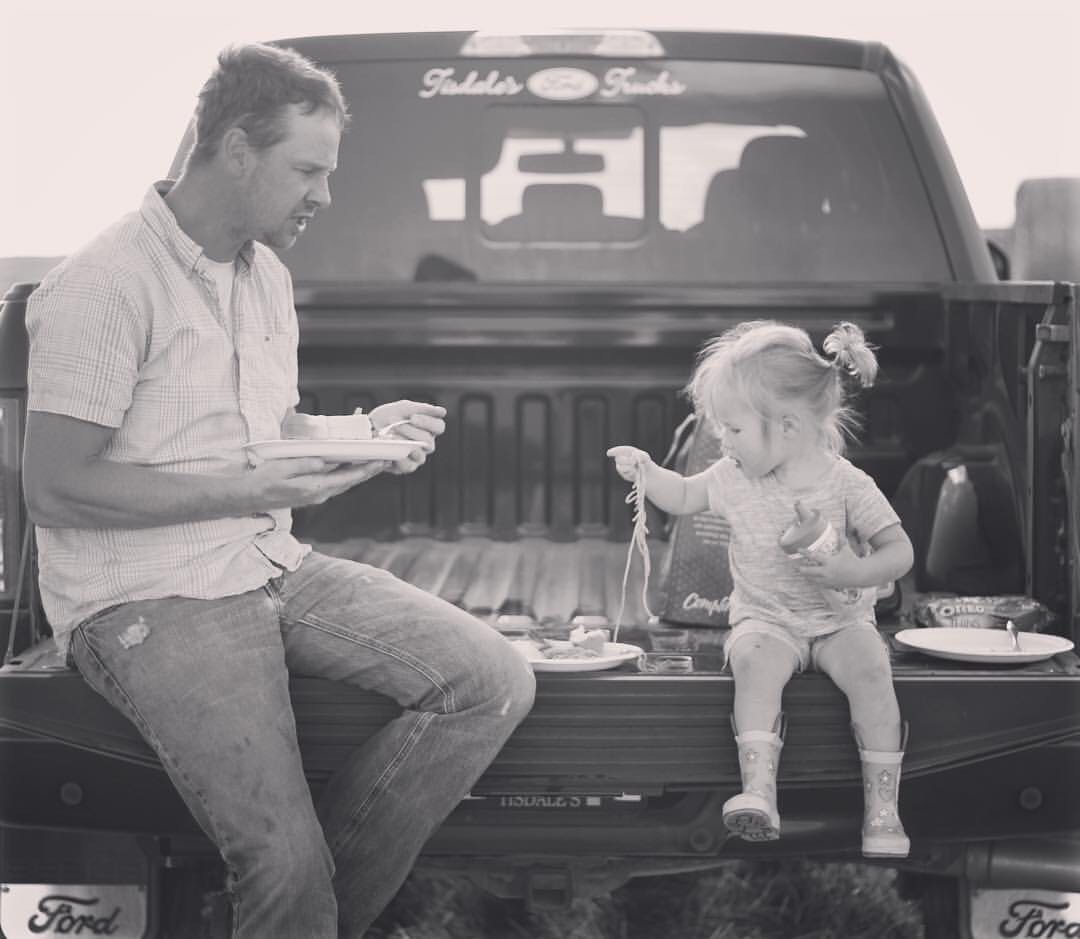 Photo of my husband Alastair and daughter Bailey having a meal in the field during harvest, Midale, Sk.| photo by Kelli Rea @ReaKelli
