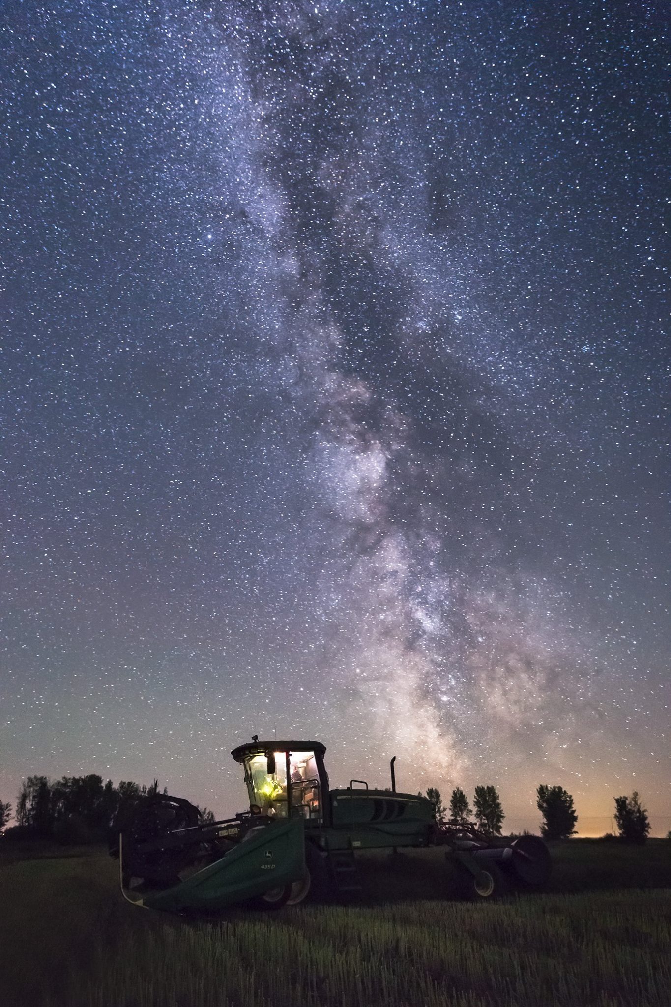 The sky was so clear last night, so while I was out taking photos I stopped in the field my dad was working on and snapped a photo of the swather in the canola and the Milky Way. | Brendon Fidek photo