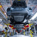 A car is hung in the air as it passes along an automated assembly line at an automobile factory in the USA.