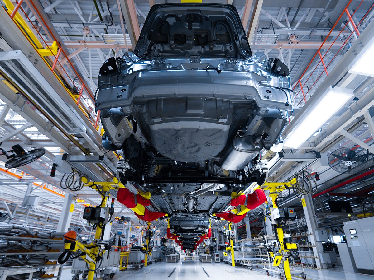 A car is hung in the air as it passes along an automated assembly line at an automobile factory in the USA.