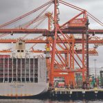 A massive Chinese container ship sits at the dock in the Port of Vancouver.