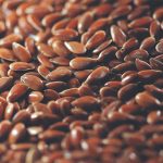 Close-up of flax seeds spread on a table.