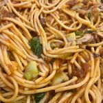 A close-up of warm pasta in a bowl.