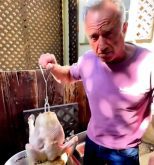 A screencap from x.com of Robert F. Kenedy Jr. about to lower a raw turkey into a vat of boiling beef tallow.