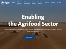 Screencap of the homepage of the Saudi Agricultural and Livestock Investment Company (SALIC) showing a drone image of two combines and a tractor pulling a grain cart in a wheat field.