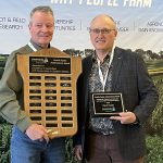 Rob Dunn, left, presents Kevin Auch with the 2025 Orville Yanke Achievement Award at the Farming Smarter Conference and Trade Show in Lethbridge.