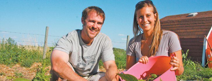 Jason Baranec and Julia Mitchell examine the fruits of their garden labours on their acreage north of Lethbridge, near Park Lake, Alta. The couple employ the principles of permaculture in efforts to create a sustainable growing system that embraces natural concepts and acknowledges humans’ role in producing their own food. | Barb Glen photo