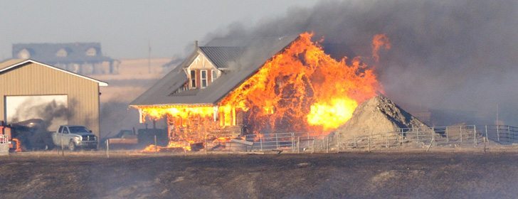A house burns after high winds sent a grass fire-turned-wildfire on a destructive path across the prairies east of Nanton, Alta., Jan 4.  |  Mike Sturk photo