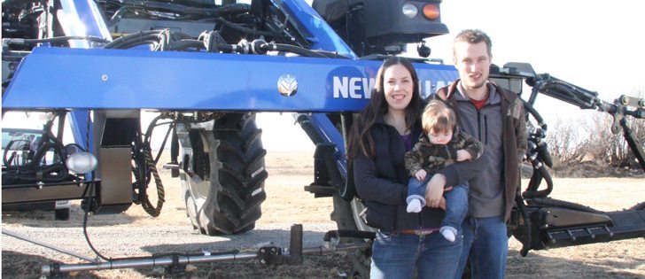 Shauna, Josh and their daughter Elizabeth Fankhauser stand next to the farm’s new high clearance sprayer. They farm near Claresholm, Alta., with Josh’s parents and uncles.  |  Barb Glen photo