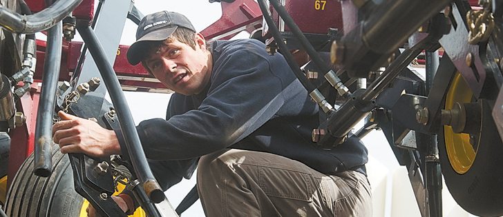 Darcy Roth works on a new Seed Hawk 65 foot air drill, getting it ready for seeding wheat at Raptor Enterprises near Hafford, Sask., on April 5.  |  William DeKay photo