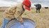 Five-year-old Marcus Mason mixes stock salt and high-magnesium mash together for cattle in a field west of Cayley, Alta. Marcus was helping out his father, Ian, and grandfather, Harley Earl. Proper herd management is critical to prevention of lameness in cows and bulls. | Mike Sturk photo)
