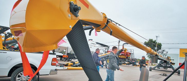 Staff from ConveyAll in Winkler, Man., set up a 100-foot grain and fertilizer conveyor before the opening of Canada’s Farm Progress Show in Regina June 20-22. The TCH 10100-SO is the largest the company makes and it hopes it will be a hit with farmers.  |  Michael Raine photo