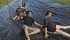 Travis, left, Nicole, Dylan and Dawn Kennedy of Luseland, Sask., take a break from the day’s chores to cool down and enjoy a ride on their homemade water slide made from recycled grain bags. | William DeKay photo