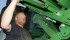 Richard Germain of Rolla, B.C., slides a pin in place as he hooks up the header to a combine for Borek Farms of Dawson Creek, B.C. Yields are disappointing in these fields, following a dry summer, but across the Prairies the wheat harvest looks strong, especially for those farmers who applied fungicides. | Mary MacArthur Photo