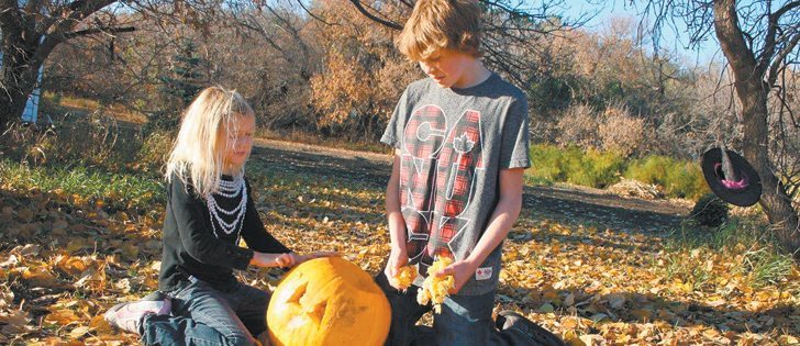 Jada and Skyler Mirosovsky dig in with hands and carving tools to turn their pumpkin into a Halloween masterpiece.  |  Jodie Mirosovsky photo