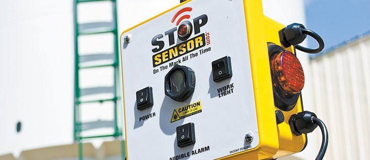The Stop Sensor emits a light beam that bounces back from reflectors on the side of the trailer. The reflector is attached to the trailer directly above the hopper gates, ensuring that the dump is on the mark every time.  |  Larry Mosbrucker photo