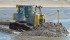 To test the integrity of the sealed electrical system, Cat had a number of prototype D7E dozers working in the ocean doing beach reclamation work. The salt water did not affect the electrical systems. | Caterpillar photo