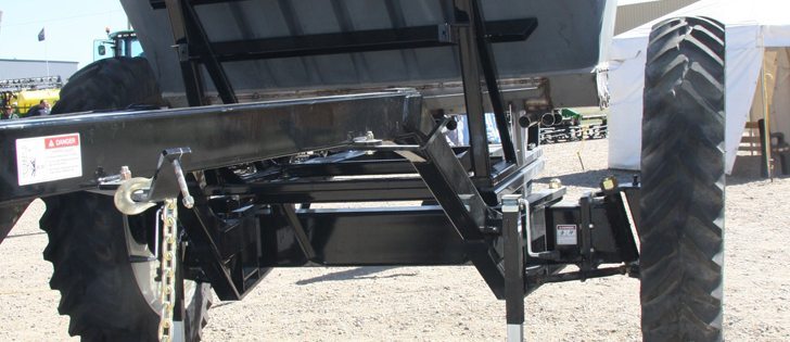 A long gooseneck runs down each side of the cart and connects to a tie rod. The tie rod connects to the steerable hub. In a turn, the outside gooseneck wants to get longer, so it pulls on its hub. The inside gooseneck wants to get shorter, so it pushes on its hub. The outside tire follows a longer arc and the inside tire tracks a short arc. As a result, we have a self-steering cart.  |  Ron Lyseng photo