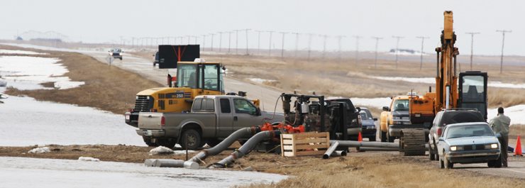 The Beaver Creek flowed over its banks and into the Austman farmyard when an ice-jam blocked a large highway culvert near Kenaston, Sask. The family says vehicles and farm buildings were damaged and the family's water and sewer systems merged when the flood water overtook their farm. Once the ice was cleared the water receeding quickly, however the family blames Saskatchewan Highways for delays in removal of the ice and additional height added to the highway in the 1980s as causes for their flood. March 7, 2006(WP photo by Michael Raine)