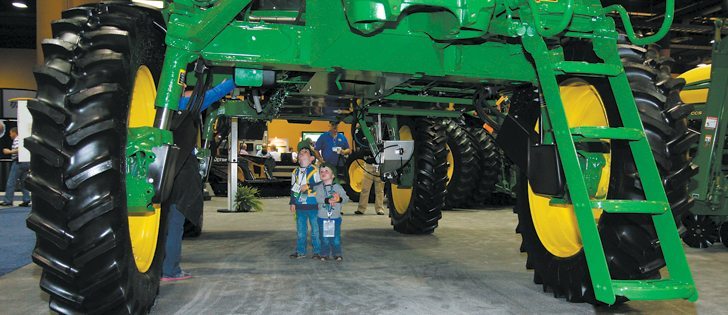 Bryson Mills and his younger brother, Hudson, check out the underbelly of a John Deere 4730 sprayer at the trade show portion of the 2013 Commodity Classic, an annual gathering of U.S. corn, soybean, wheat and sorghum growers. This year’s show, held in Kissimmee, Florida, Feb. 28 
to March 2, set a new record with 6,080 attendees.  |  Sean Pratt photo