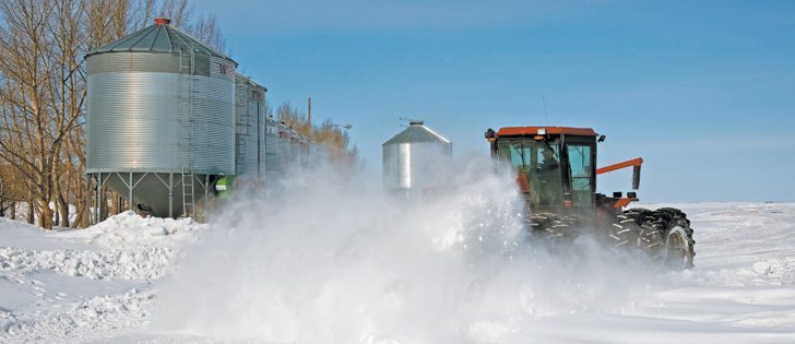 Heavier than normal snowfall in much of Manitoba and Saskatchewan is setting off flood alarms this spring, but it has also kept farmers busy. Gerard Zdunich cleared snow in his farmyard east of Kenaston, Sask., March 25.  |  William DeKay photo