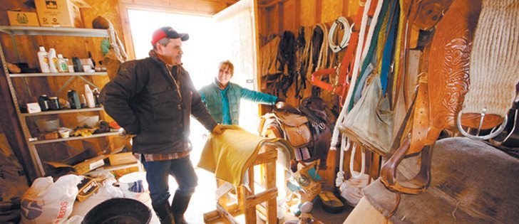 Michelle Glover Burstrom and Ed Burstrom stand in Ed’s parents’ tack shed. The couple shares pastureland, grazing licences and responsibilities for the livestock with the parents, who live nearby.
|  Laura Keil photo