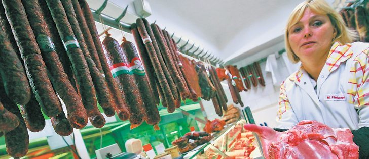 A butcher shows a piece of pork to a prospective buyer in a shop in Budapest, Hungary. Canada is vying for more access to European beef and pork markets as part of a larger European Union-Canada trade agreement.  |  Reuters/Laszlo Balogh photo