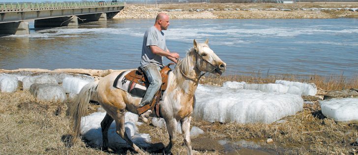 Dan Roy’s saskatoon berry orchard was partially drowned in 2011 when the Manitoba government deliberately flooded farmland. He’s keeping a close eye on the Portage Diversion this spring, which has again been opened.  |  Ed White photo 