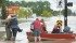 A woman is rescued by boat in High River, Alta. A state of emergency was declared in the town and residents were evacuated. | Mike Sturk photo