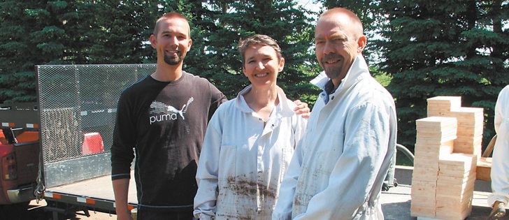  Aaron, left, Sara and Henry have 750 bee hives near Grandora, Sask. Sun River Honey sells to food processors and honey packers in Canada and the United States. |  Brian Cross photo