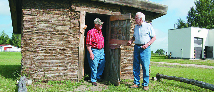 Volunteers Frank Schwengler and Harvey Uffelman tour the sod house built by the Beiseker Station Museum Society. It constructed a sod house to mark 2005, the province’s centennial year.  |  karen morrison photo