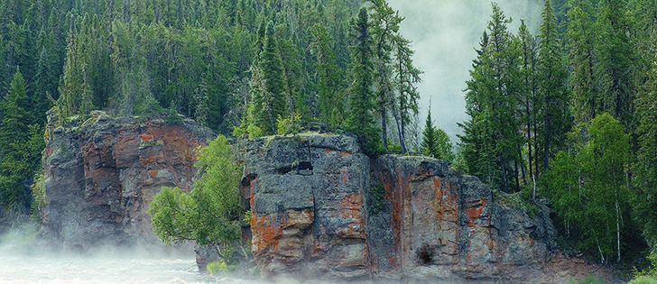 Early morning fog rises around the entrance to Skull Canyon, Clearwater River, Saskatchewan | Arlene and Robin Karpan Photo