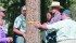 A tour group from Clearwater County takes the diameter and circumference of a lodgepole pine. The special tape measure goes around the tree and can calculate circumference and diameter. | Barbara Duckworth photo