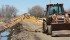 A backhoe operator clears a drainage ditch west of Warman, Saskatchewan, on May 4, 2013.