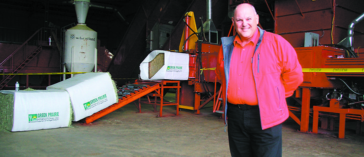 Chris Whittle, in charge of procurement and logistics for Green Prairie International Inc. based in Lethbridge, was on hand to conduct tours of the facility Sept. 7 during the company’s 25th anniversary celebration. In the background is a hay compressing machine that wraps compressed bales of timothy and alfalfa hay for shipment to overseas markets.  |  Barb Glen photos