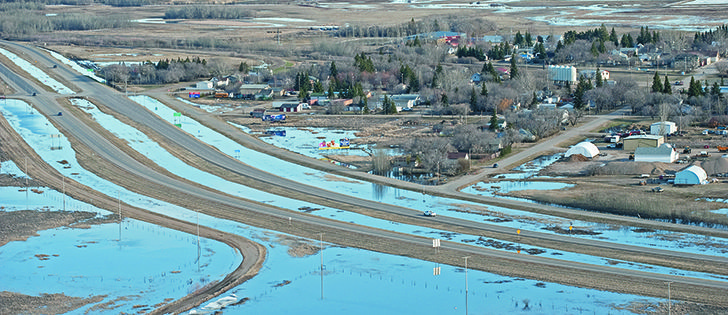 Rural municipalities in Saskatchewan have asked the province to negotiate a compensation policy to better deal with damages caused when floods reroute highway traffic onto grid roads. |  File Photo 