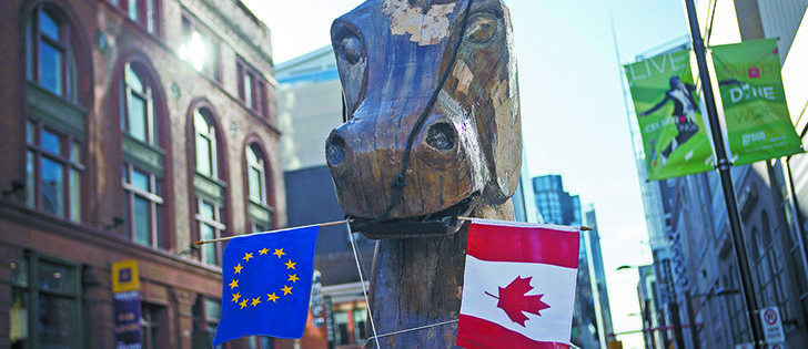 A giant Trojan horse statue holding Canadian and European Union flags in its mouth, was set up by the social activist group Council of Canadians in front of the Ontario Investment and Trade Centre in Toronto Nov. 4 to protest the Comprehensive Economic and Trade Agreement between Canada and the EU.  |  Reuters/Mark Blinch Photo