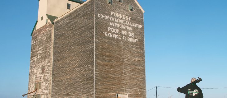 Matt Tolton hikes with his tripod to take a photo of a wooden grain elevator at Forrest, Man. Tolton belongs to an informal community known as vatorologists, who are fascinated by grain elevators and their iconic role in the development of Western Canada.  |  Robert Arnason photo